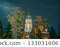 The majestic bell tower of the Assumption Cathedral behind the Tula Kremlin wall, brightly illuminated at night. A fairytale view of Russian Orthodox architecture in Tula, Russia. 133031606