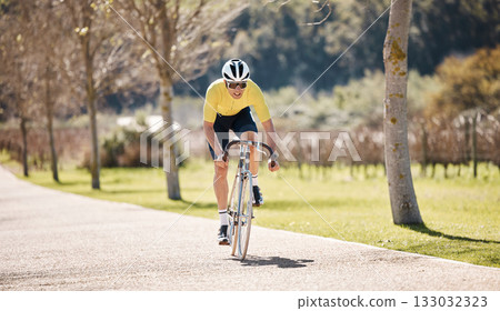Man, athlete and cycling path in park, exercise and training of triathlon sports in sunshine. Cyclist, bicycle and ride on bike outdoor in summer adventure, fitness and cardio performance in nature Man, athlete and cycling path in park, exercise and training of triathlon sports in sunshine. Cyclist, bicycle and ride on bike outdoor in summer adventure, fitness and cardio performance in nature 133032323
