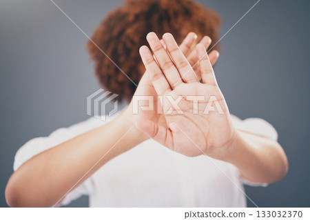 Closeup, hands and woman in studio for stop, warning or domestic violence symbol on grey background. Zoom, justice and hand of girl in protest, caution and protection, scared and abuse awareness Closeup, hands and woman in studio for stop, warning or domestic violence symbol on grey background. Zoom, justice and hand of girl in protest, caution and protection, scared and abuse awareness 133032370