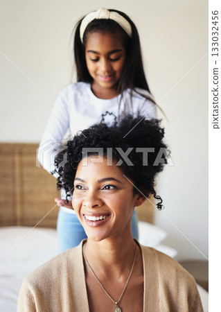Daughter or child brushing mother hair and bonding in a home bedroom smile, adorable and happy together. Single mom, kid and mum relax spending quality time grooming in a house in happiness 133032456
