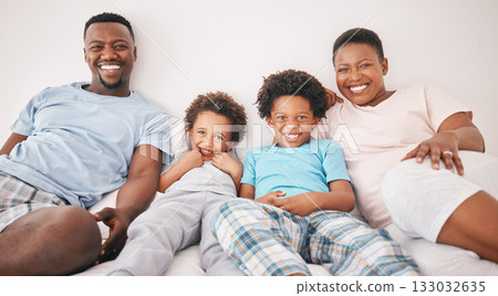 Black family, smile and portrait of parents with children on bed for bonding, quality time and relax together. Love, happy and African mom, dad and kids in bedroom enjoy morning, weekend and holiday 133032635