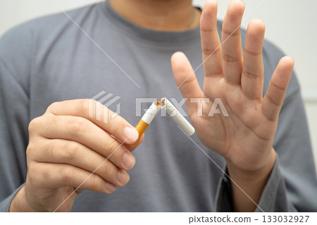 Quit smoking, Asian teenage man breaking destroy cigarette in hand. Quit smoking, Asian teenage man breaking destroy cigarette in hand. 133032927