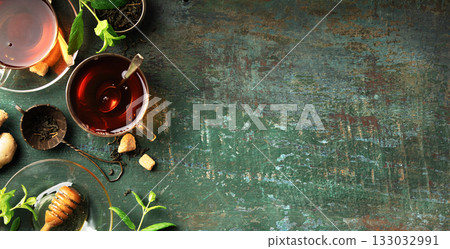 Herbal Tea with Lemon, Ginger, Mint, and Honey on Rustic Background 133032991