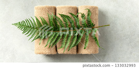 Spa Towels with Green Fern on Light Minimal Background Spa Towels with Green Fern on Light Minimal Background 133032993