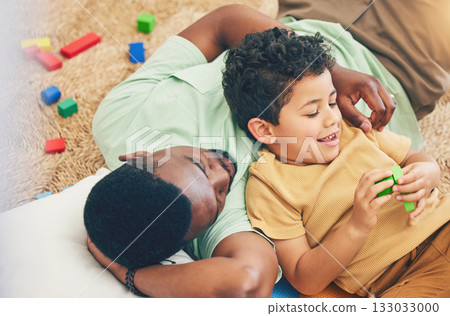 Relax, father and boy on floor with toys for playing, creative activity and fun bonding in living room. Education, child development and kid enjoy building blocks, games and relax with dad at home Relax, father and boy on floor with toys for playing, creative activity and fun bonding in living room. Education, child development and kid enjoy building blocks, games and relax with dad at home 133033000