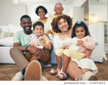 Happy, interracial and portrait of a big family bonding, smiling and playing during a visit. Smile, quality time and parents, grandparents and children sitting in a living room for happiness at home Happy, interracial and portrait of a big family bonding, smiling and playing during a visit. Smile, quality time and parents, grandparents and children sitting in a living room for happiness at home 133033023