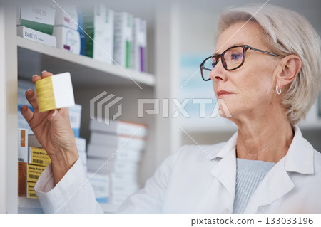 Pharmacist, pharmacy and woman reading side effects on medication label, pills or box in drugstore. Healthcare, wellness and medical doctor looking at medicine, antibiotics or drugs or vitamins 133033196