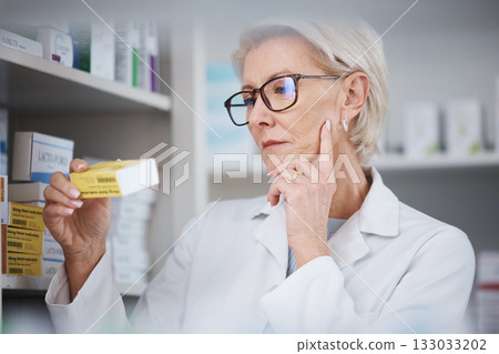 Pharmacy, pharmacist and woman reading medication label, pills or box in drugstore. Healthcare, wellness and elderly medical doctor looking at medicine, antibiotics or drugs, vitamins or supplements. Pharmacy, pharmacist and woman reading medication label, pills or box in drugstore. Healthcare, wellness and elderly medical doctor looking at medicine, antibiotics or drugs, vitamins or supplements. 133033202