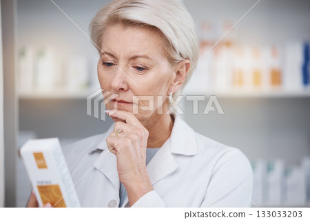 Pharmacist, pharmacy and woman reading medicine label, pills or box in drugstore. Healthcare, thinking and elderly medical doctor looking at medication, antibiotics or drugs, vitamins or supplements. Pharmacist, pharmacy and woman reading medicine label, pills or box in drugstore. Healthcare, thinking and elderly medical doctor looking at medication, antibiotics or drugs, vitamins or supplements. 133033203