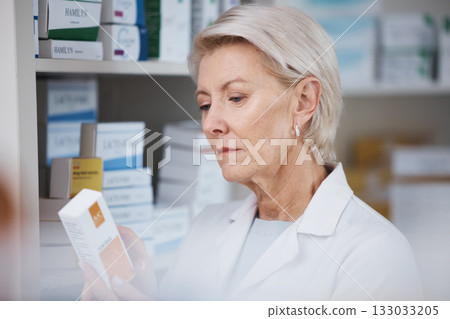Elderly pharmacist, medicine reading and stock in a healthcare, wellness and pharmaceutical store. Pharmacy inventory, working senior woman and medical product check of a employee at a drugstore Elderly pharmacist, medicine reading and stock in a healthcare, wellness and pharmaceutical store. Pharmacy inventory, working senior woman and medical product check of a employee at a drugstore 133033205