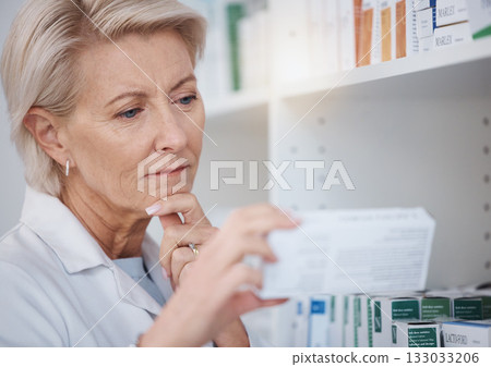 Pharmacy, pharmacist and woman reading medicine label, pills or box in drugstore. Healthcare, thinking and elderly medical doctor looking at medication, antibiotics or drugs, vitamins or supplements. Pharmacy, pharmacist and woman reading medicine label, pills or box in drugstore. Healthcare, thinking and elderly medical doctor looking at medication, antibiotics or drugs, vitamins or supplements. 133033206