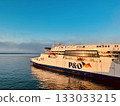 PO ferry ship sailing across calm sea during golden hour with clear blue sky 133033215