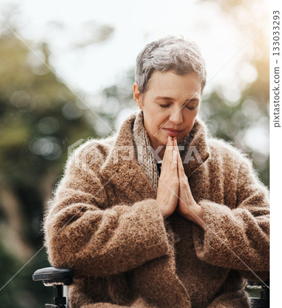 Old woman in wheelchair, praying in garden with worship and God, faith and religion with peace outdoor. Spiritual, female person with disability has gratitude and faith, prayer and guidance 133033293