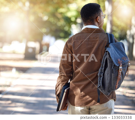 Black man, walking or backpack on campus, park nature or garden for college, university or school studying development. Student, gen z and person with learning books, education bag or growth mindset 133033338