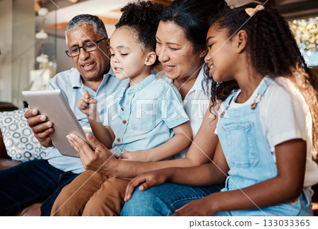Relax, family tablet and grandparents with girls on sofa in home living room for social media or video streaming. Technology, care and happy grandfather, grandma and kids bonding with touchscreen. 133033365