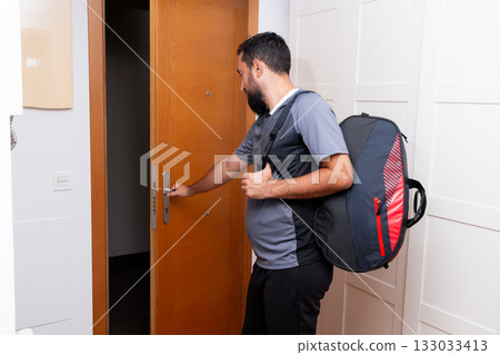 Young caucasian male entering room with backpack Young caucasian male entering room with backpack 133033413