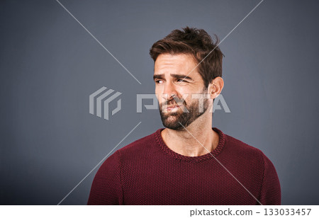 Doubt, thinking and face of unsure man in studio with worry, uncertain and thoughtful on gray background. Confused, mockup space and isolated male person skeptical for decision, choice and question 133033457