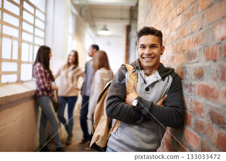 Education, arms crossed and portrait of man in school hallway for studying, college and scholarship. Future, happy and knowledge with student leaning on brick wall for university, academy and campus Education, arms crossed and portrait of man in school hallway for studying, college and scholarship. Future, happy and knowledge with student leaning on brick wall for university, academy and campus 133033472