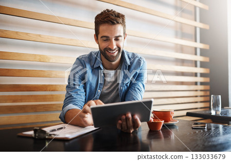 Online, typing and a man with a tablet at a cafe for communication, connectivity and administration. Happy, remote work and a male entrepreneur reading from the web with technology at a coffee shop 133033679