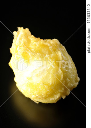Egg tempura photographed alone against a black background Egg tempura photographed alone against a black background 133033840