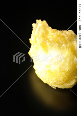 Egg tempura photographed alone against a black background Egg tempura photographed alone against a black background 133033845