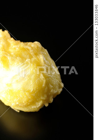 Egg tempura photographed alone against a black background Egg tempura photographed alone against a black background 133033846
