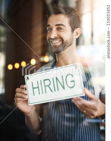 Man with hiring sign, window with job opportunity advertising, happy waiter or barista in portrait. Small business, recruitment and male owner with onboarding, promo poster for new hire at cafe Man with hiring sign, window with job opportunity advertising, happy waiter or barista in portrait. Small business, recruitment and male owner with onboarding, promo poster for new hire at cafe 133033852