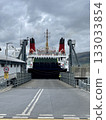 Large car and passenger ferry docked at port terminal ramp ready for loading 133033854