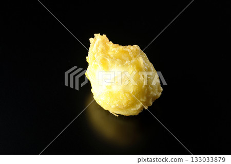 Egg tempura photographed alone against a black background Egg tempura photographed alone against a black background 133033879