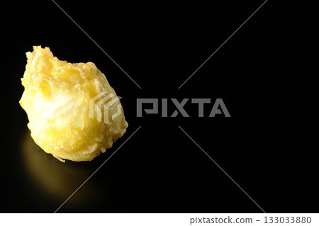 Egg tempura photographed alone against a black background Egg tempura photographed alone against a black background 133033880