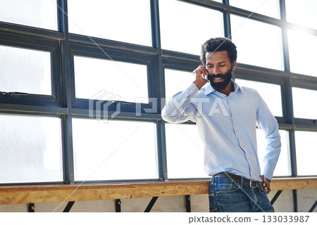 Window, thinking and phone call with a business man in negotiation at the office for planning or opportunity. Idea, vision and communication with a male employee in the workplace during his break Window, thinking and phone call with a business man in negotiation at the office for planning or opportunity. Idea, vision and communication with a male employee in the workplace during his break 133033987