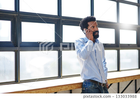Window, flare and phone call with a business man in the office for planning, communication or negotiation. Mobile, contact and corporate with a male employee standing in a workplace during his break 133033988