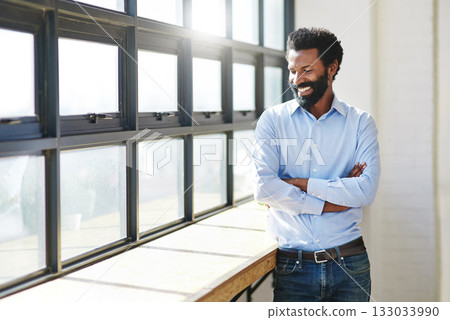 Window, lens flare and a business man arms crossed in the office with a smile or mindset of future success. Happy, vision and thinking with a male employee standing in the workplace during his break 133033990