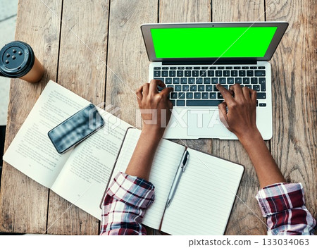 Woman, hands and laptop of student on green screen mockup above for studying, education or research at cafe. Top view of female person hand on computer display for university project at coffee shop 133034063