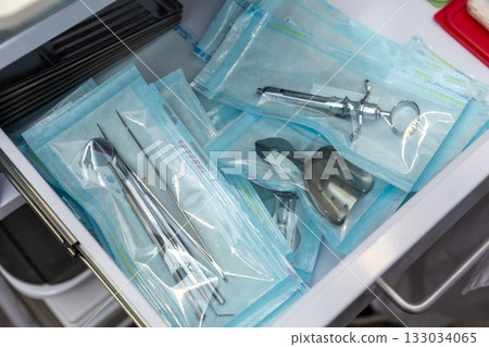 A drawer full of individually sealed dental tools 133034065
