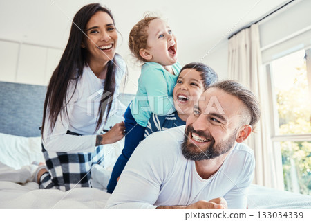 Family, portrait and laughing on bed in house, having fun and bonding together. Comic, love and care of happy father, mother and kids or boys playing, smile and enjoying quality time in home bedroom. Family, portrait and laughing on bed in house, having fun and bonding together. Comic, love and care of happy father, mother and kids or boys playing, smile and enjoying quality time in home bedroom. 133034339