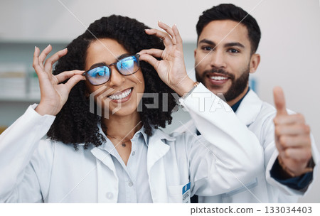 Vision portrait, doctor thumbs up and smile of a female healthcare worker in a hospital. Agreement, glasses choice and happy woman looking at lens and frames options in a optometrist clinic Vision portrait, doctor thumbs up and smile of a female healthcare worker in a hospital. Agreement, glasses choice and happy woman looking at lens and frames options in a optometrist clinic 133034403
