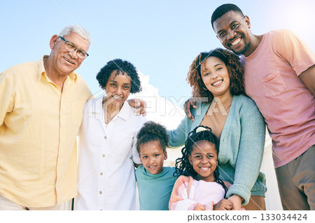 Hug, happy and portrait of an interracial family with a smile, happiness and care on the lawn. Looking, diversity and parents, grandparents and children with love, smiling and bonding in the garden Hug, happy and portrait of an interracial family with a smile, happiness and care on the lawn. Looking, diversity and parents, grandparents and children with love, smiling and bonding in the garden 133034424