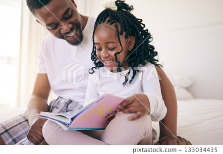 Black family, children and a father reading to his daughter in the bedroom of their home together for storytelling. Kids, education or books with a man and girl child sitting on the bed to read 133034435