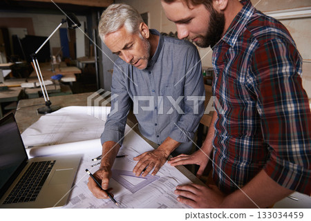 Architect men, teamwork and drawing blueprint with discussion, construction goal or vision in workshop. Senior man, young male partner and paperwork for building, property or real estate development Architect men, teamwork and drawing blueprint with discussion, construction goal or vision in workshop. Senior man, young male partner and paperwork for building, property or real estate development 133034459