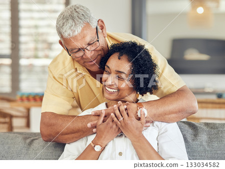 Love, relax and senior couple hug, care and enjoy quality bonding time on home living room sofa. Retirement happiness, marriage smile and romantic elderly husband, wife or people happy together 133034582