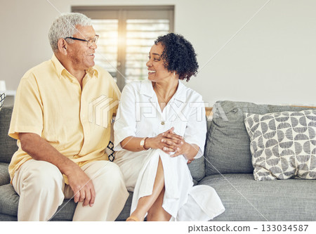 Love, talking and senior couple on couch, quality time and happiness on break, affection and retirement. Romance, old man and mature woman on sofa, romance and conversation in living room and joyful 133034587