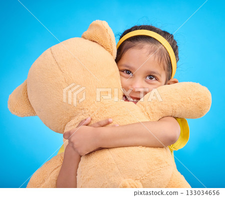 Mockup, portrait and girl with teddy bear, hug and happiness against a blue studio background. Face, female kid and young person embrace fluffy toy, cheerful and child development with fun and joy Mockup, portrait and girl with teddy bear, hug and happiness against a blue studio background. Face, female kid and young person embrace fluffy toy, cheerful and child development with fun and joy 133034656