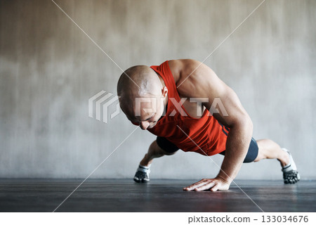 Gym, man and one arm push up for exercise performance, workout determination and sports training focus. Athlete discipline, strength endurance mockup or active male person concentrate on floor pushup 133034676