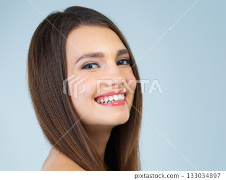 Hair, beauty and portrait of woman with smile on blue background for wellness, skincare and spa treatment. Salon aesthetic, dermatology and face of happy girl with cosmetics, makeup and facial glow Hair, beauty and portrait of woman with smile on blue background for wellness, skincare and spa treatment. Salon aesthetic, dermatology and face of happy girl with cosmetics, makeup and facial glow 133034897