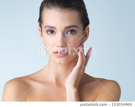 Skincare, cosmetics and portrait of young woman in studio isolated on blue background in salon makeup. Beauty, portrait of model from Spain and spa facial treatment for fresh clean skin with mockup. Skincare, cosmetics and portrait of young woman in studio isolated on blue background in salon makeup. Beauty, portrait of model from Spain and spa facial treatment for fresh clean skin with mockup. 133034969
