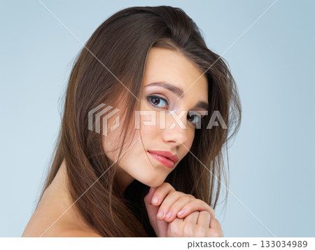 Makeup, beauty and portrait of woman in studio on blue background for wellness, skincare and facial treatment. Salon aesthetic, dermatology and face of girl with cosmetics, confidence and glowing Makeup, beauty and portrait of woman in studio on blue background for wellness, skincare and facial treatment. Salon aesthetic, dermatology and face of girl with cosmetics, confidence and glowing 133034989