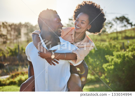 Black couple, piggy back or bonding in park, nature garden or sustainability environment in fun activity game or love. Smile, happy man or afro woman in carry support, trust or freedom playful date 133034994