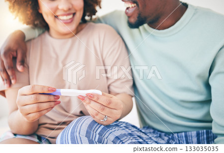 Happy, couple and pregnancy test, smile and excited for good news, positive and results in their house. Hands, woman and man with home testing kit, pregnant and fertility or ivf success while hugging 133035035