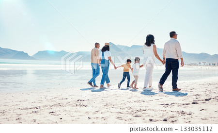 Beach, love and big family holding hands while walking on a vacation, adventure or weekend trip. Travel, seaside and children on walk with their parents and grandparents by the ocean while on holiday Beach, love and big family holding hands while walking on a vacation, adventure or weekend trip. Travel, seaside and children on walk with their parents and grandparents by the ocean while on holiday 133035112